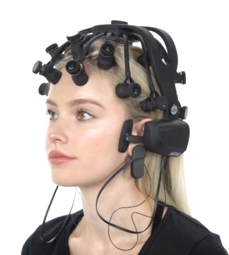 A woman wearing an EEG headband, monitoring brain activity during a research study.