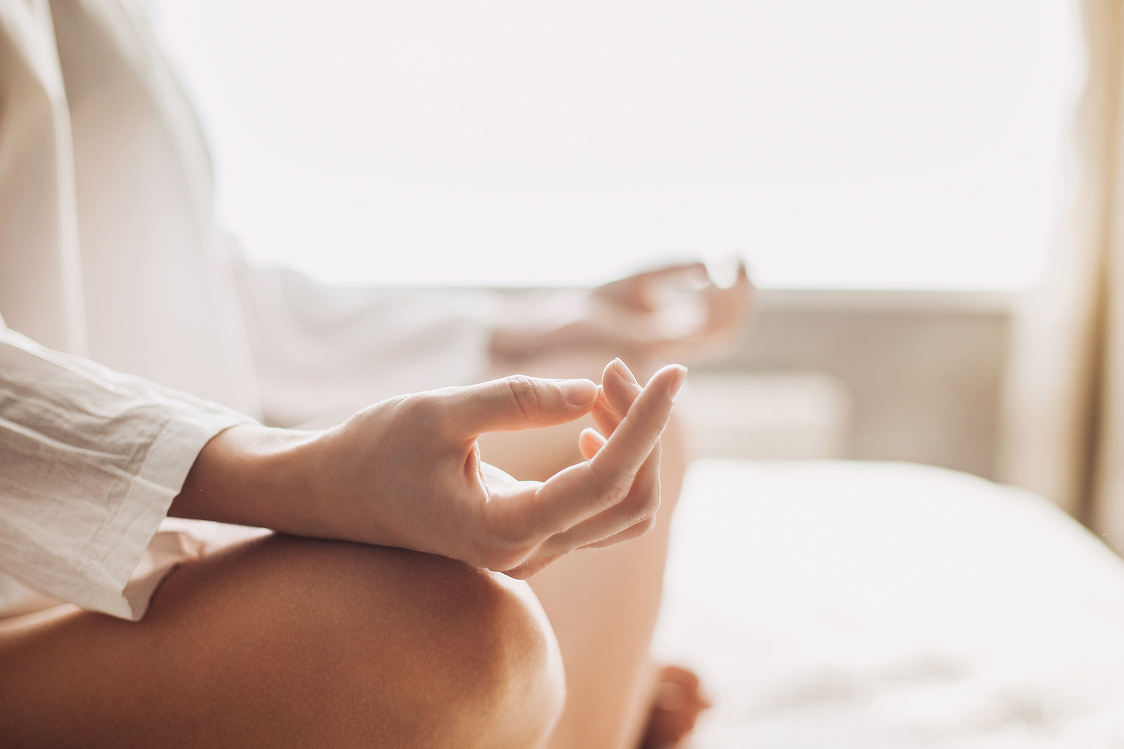 Close-up of someone meditating in a bright room as they explore what could be the best depression treatments for them. 