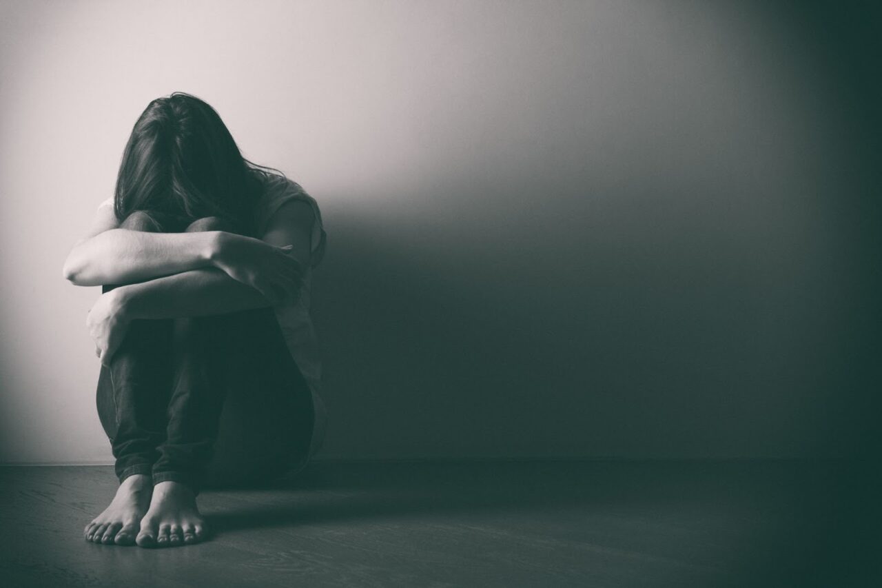 Understanding Brain Mapping Therapy - A Woman Sitting On The Floor With Her Hands Folded Representing Brain Mapping And Mental Health Disorders 1280x853 