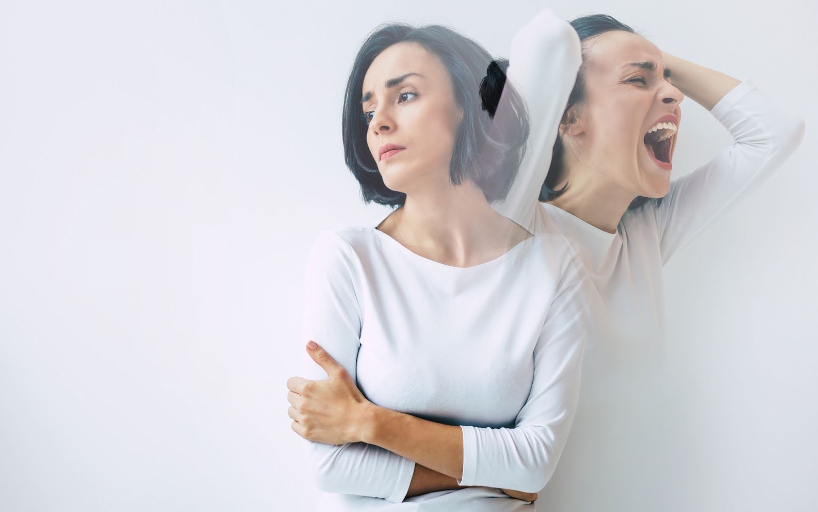 A woman in distress holds her head and screams, reflecting the turmoil of manic episodes in bipolar disorder during TMS therapy.