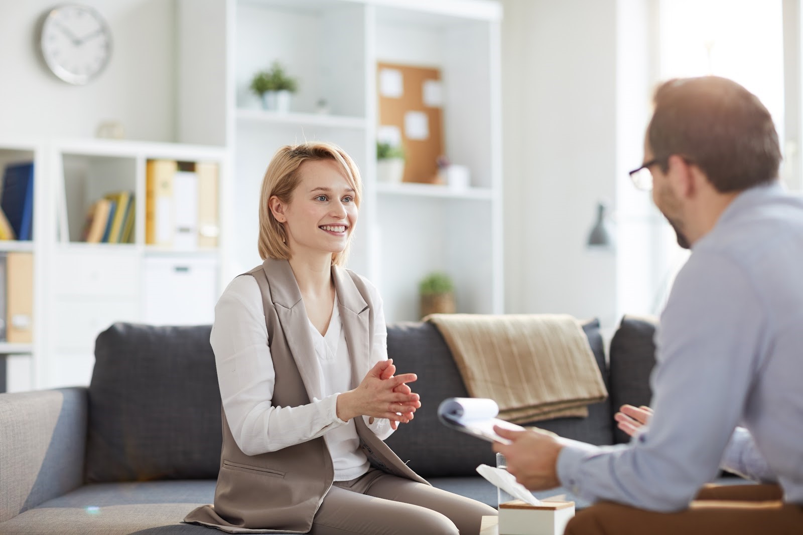 A patient and doctor sit in a bright office discussing OCD treatment options.